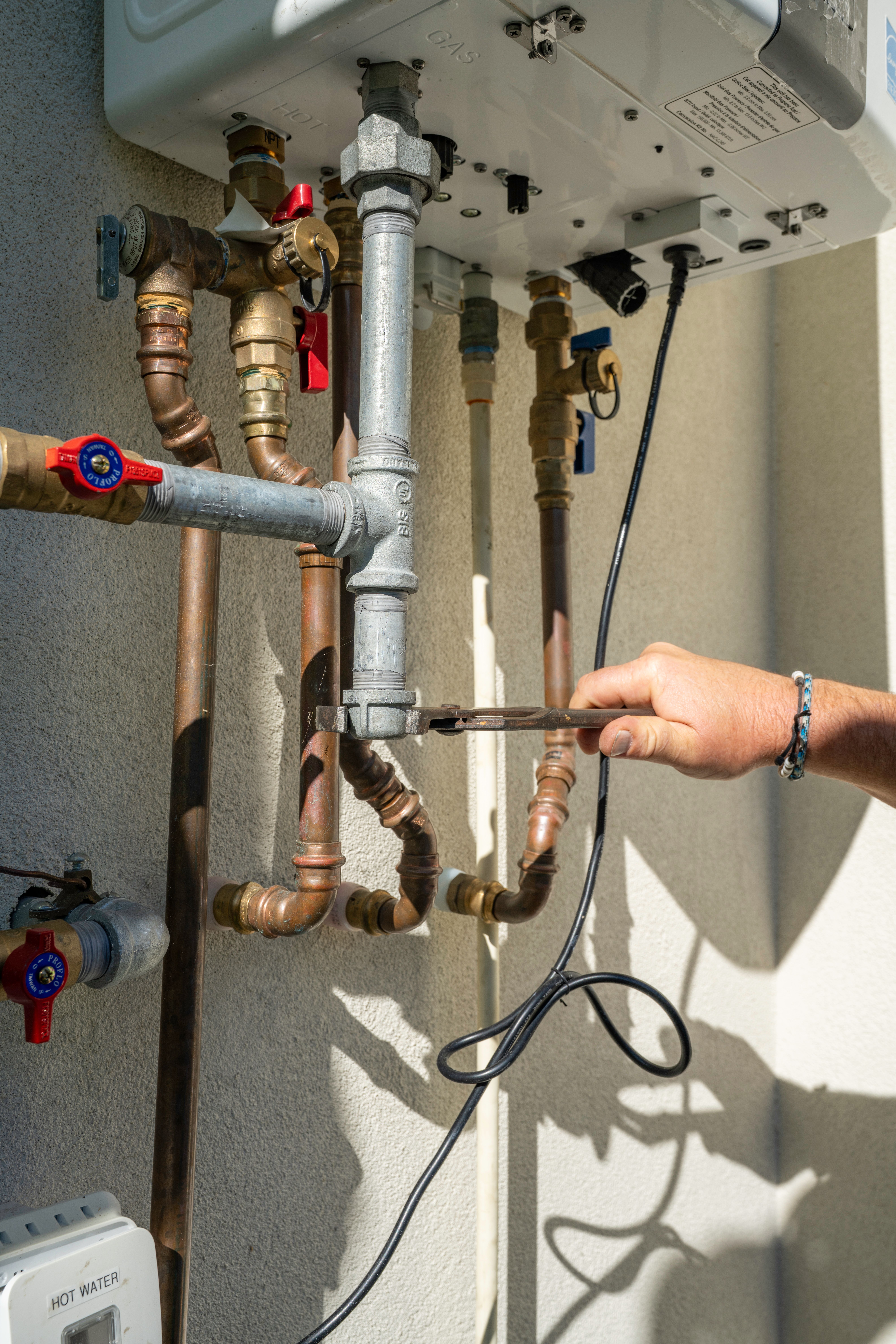 Licensed A-1 gas technician performing a gas line safety check in Naples, FL