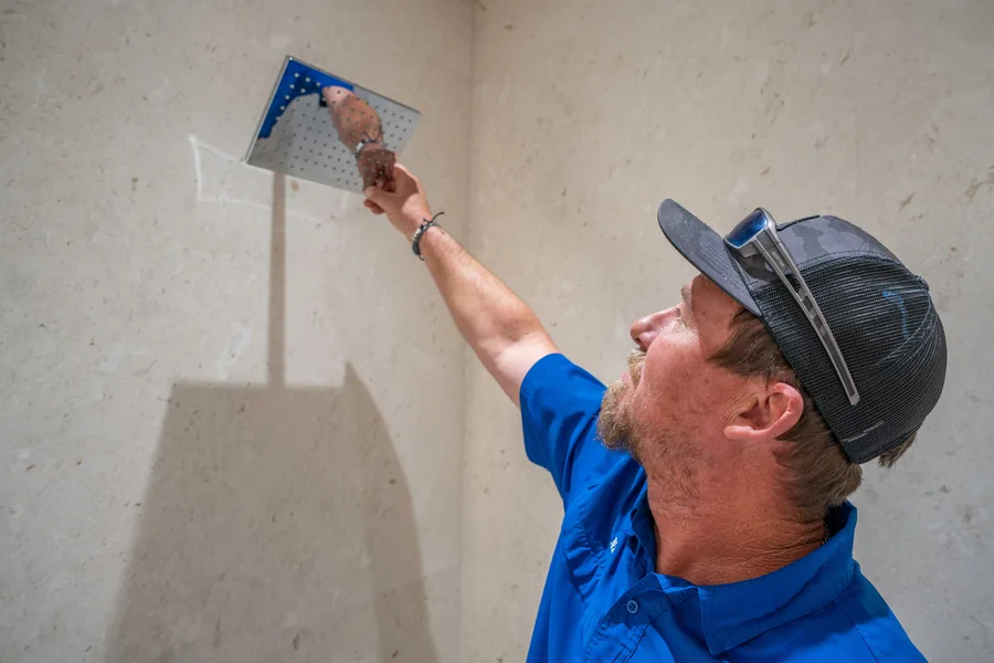 A-1 Plumbing technician using electronic leak detection equipment to locate a slab leak in Naples, FL